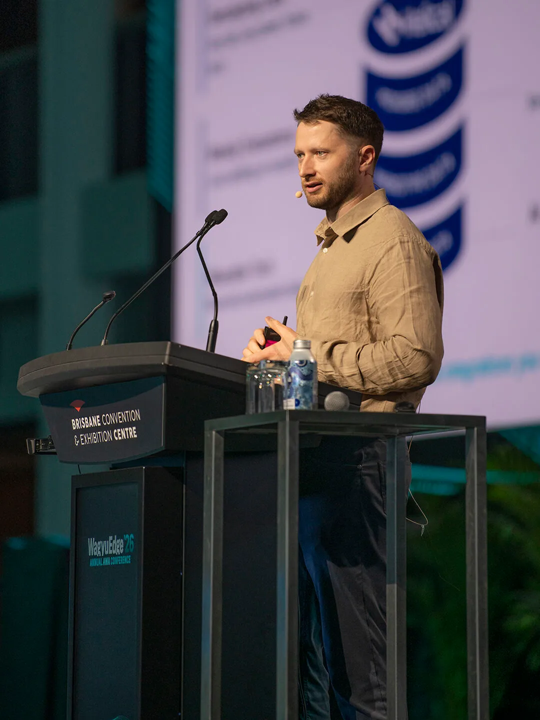 Dan Garrick speaking at a lectern at the WagyuEdge'26 conference, Brisbane Convention and Exhibition Centre
